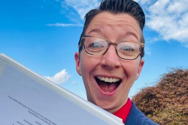 Shenandoah University Ph.D. in educational leadership student Annmarie Noonan '24, holding her award-winning dissertation.